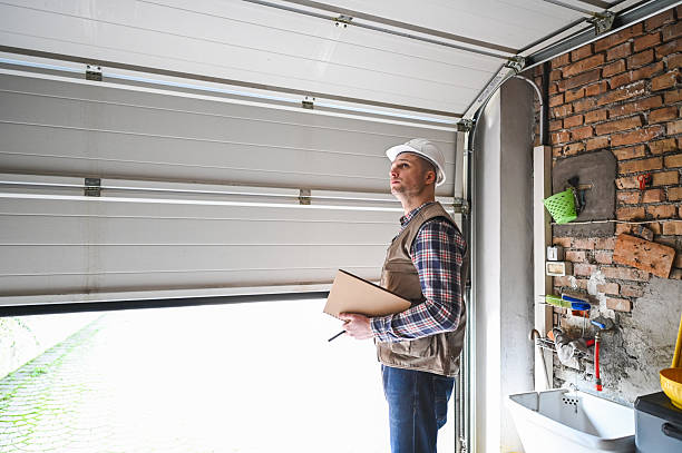Construction worker inspecting garage door installation in residential building